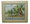 A framed tile with a painting of Little Bay, St. Lawrence Gap in Barbados by Jill Walker