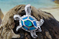 Turtle pendant made of sterling silver and blue opal. 