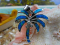 Palm pendant made of sterling silver and blue opal.