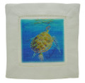 A cocktail napkin with a turtle surfacing.