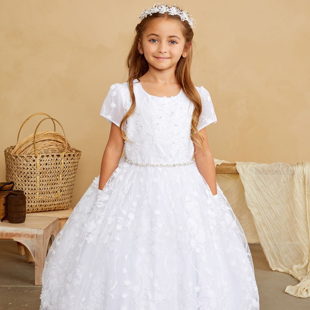 a little girl in a communion dress