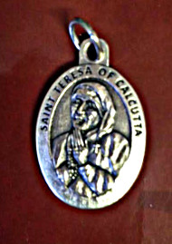 Silver Oxidized medal of St. Mother Teresa. Back of medal says "Pray for Us". Dimensions" 1"H x .75"W. Canonization Date: September 4, 2016. Feast Day: September 5