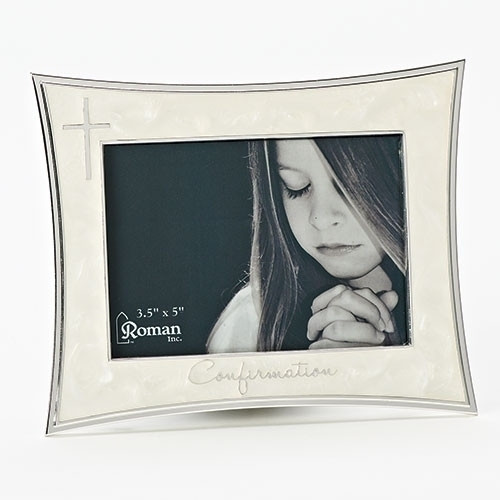 5.5"H Ivory Confirmation Frame from the Caroline Collection. Holds a  5"W x 3 1/2"H picture. Adorned with a silver cross on left side and the word "Confirmation" across the bottom of frame. Zinc alloy, lead free.