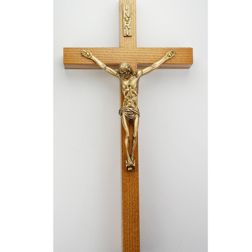 This beautifully designed wall crucifix is made from walnut and decorated with a gold corpus. Crucifix comes in two sizes: 6 inches or 8 inches.  It is decorated in with a gold figure and a mini plaque that reads “INRI".