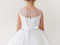 close up of back of  Girls white communion dress with rhinestone belt and tulle skirt 