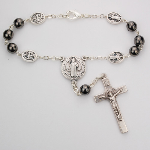 St Benedict Hematite Auto Rosary. 7MM hematite beads with silver oxidized crucifix and center. Comes on a hang tag. 