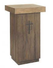 Simple wooden stand shaped like a rectangle with a square platform on top and a cross on the front.
 