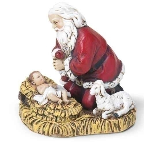 Christmas ornament of Santa kneeling next to baby Jesus in a manger. 