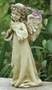 A praying angel cement statue with pink flowers tucked behind her wings in an outdoor garden. 16" "Praying Angel Garden Planter" Angel Planter is 16"H x 7" W x 9"D. The Praying angel Planter is made of a resin/stone mix. A beautiful addition to any inside or outside garden!!