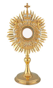 Baroque Angel Monstrance. A royal crown in gold and silver-plate flanked by a pair of Cherubims adorn the monstrance. Nine Angel heads on silver plated clouds form a wreath around the luna casing. Gold-rimmed glass luna for 2-3/4" host. A full luna can be added for an additional cost.  Imported from Europe