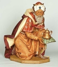 King Gaspar kneeling and presenting his gift that is resting on a small decorative pillow. Marble Based Resin