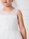 Close up of girls white communion dress illusion neckline 