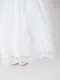  Close up of lace hem on girls white communion dress 
