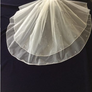 First Communion is a special occasion for your children. When it is time for your daughter’s first communion, complete her special outfit with this beautiful Christie Helene veil. This veil is designed with a layered look for something simple and unique. The veil is adorned with scattered pearls to add to the look. This veil is simple, yet stunning, making it a perfect choice for your daughter’s first communion. The layered look and pearls add a touch of style to this beautiful veil. The veil has a comb hold, making it easy to place in your daughter’s hair. Available in White or Diamond White