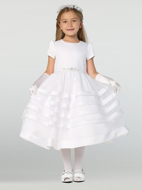 This unique and simple Communion dress offers a stunning look. Your daughter or granddaughter will love this gorgeous dress! It features a satin trimmed skirt, a beaded belt that ties in a bow in the back, and a button closure in the back.
Details:
Satin with organza overlay bodice
Organza skirt with satin trim
Beaded belt
Bow in the back at waistline
Cap-length puff sleeves
Tea length
Made in the U.S.
This gorgeous and elegant dress is a great option for First Holy Communion. Be sure to complete the look with a veil and accessories and shop our collection now!
3 dress limit per order!
