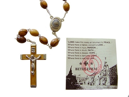 8mm Olive Wood oval rosary mounted on a silver plated chain with centerpiece containing Soil from Bethlehem where Jesus was born. Rosary is about 21" inches long. This rosary is hand made in Bethlehem, the Holy Land. A very popular choice.  