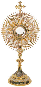 Image of a 24K gold-plated monstrance with silver filigree. The base features four oxidized medallions to represent the four evangelists. The lunula is available with either a clip style or enclosed glass.