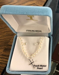 Freshwater pearl 4mm 16" necklace. The necklace includes a small budded cross in solid .925 sterling silver.  This freshwater pearl 4mm bead necklace and earrings set comes in a deluxe velvet box. Made in the USA
