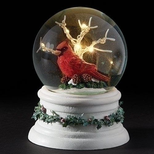 Image of the Cardinal and LED Tree In Dome snow globe that features a hand-painted cardinal resting on spruce tree branches and pine cones.