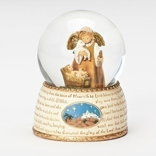 A nativity snow globe with a little Angel holding a lamb looking down over the baby Jesus.