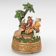 Image of The First Noel Musical Nativity resin decor that is carefully handcrafted into the classic Nativity scene with palm trees.