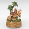 Image of The First Noel Musical Nativity resin decor that is carefully handcrafted into the classic Nativity scene with palm trees.