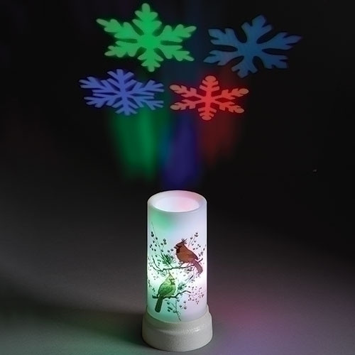 Plastic projector candle with cardinals painted on side and snowflakes projected on the ceiling.