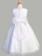 back of girls sleeveless glitter tulle First Communion dress with beaded trim waistline featuring a white bow
