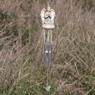 Angel praying atop a wind chime with a bluebird hanging below.