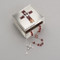 2.25"H Confirmation Keepsake Box. This confirmation box has a brown enameled cross on the top of the lid. The cross is adorned with a silver dove and flame icons at the bottom of the cross.  Made of a zinc alloy that is lead free. 