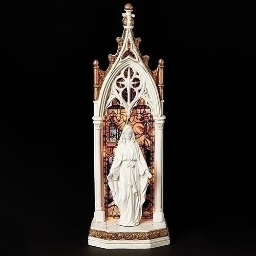 Our Lady of Grace Arched Window LED Figure. The beautiful figure stands in front of a stained glass window. This figure lights up with 3AAA batteries NOT INCLUDED.  Figure stands 11.75"H and is made of a resin/stone mix.