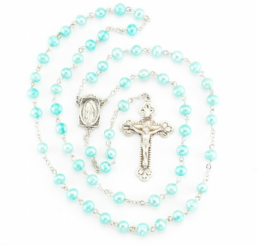 Rosary made with 6mm blue freshwater pearls. Blue pearl rosary has a detailed sterling silver Miraculous Centerpiece with a 1-7/8" sterling silver Crucifix. Rhodium plated brass findings.  Rosary comes with a deluxe velour gift box. Made in the USA.