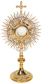 This monstrance is 24K gold-plated with silver plated highlights.
• The monstrance is available with either a clip-style, glassless luna or with a secure, acrylic-glass enclosed luna.
• The gold-rimmed glass luna holds a 2 3/4-inch host.
• Dimensions of the entire monstrance are 22 3/4"  tall, with a 11 1/2" face, and 7" base.
• Order a case separately to safely store the monstrance.
