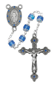7mm blue glass capped beads with pewter our Miraculous Medal Center and Crucifix.  Both the center and crucifix have blue stones embedded. 20" in Length. Deluxe Gift Box Included. Made in the USA