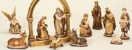  11 Piece Traditional Nativity Set. 6" Nativity Set is gold tones.  Nativity set is done in delicate shades of brown and gold 11-piece set includes : Baby Jesus, Mary, Joseph, Angel, Three Wise Men, Shepherd, sheep, donkey and cow Dimensions: Baby Jesus: 2"H x 2.75"W x 2"D Mary: 4.25"H x 2.5"W x 2.25"D Joseph: 5.75"H x 2.5"W x 2.5"D Angel: 5"H x 3.5"W x 2.75"D Shepherd: 6"H x 2.5"W x 2"D Three Wise Men: 6"H x 2.5"W x 2.5"D. Nativity set is made of a resin material. **** Arch is not included with this set 