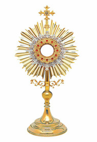 Traditional Roman Monstrance 10-416.  28"H - Silver plated layer of rich floral fililgree over golden rays. Red stone accents on decorative sculpted rim.  Includes Case. Imported From Europe. Gold-rimmed glass Luna for 2-3/4" host. A full Luna can be added to monstrance at an addition price. *As some items are made to order, Please allow 4-6 weeks for delivery. 

 