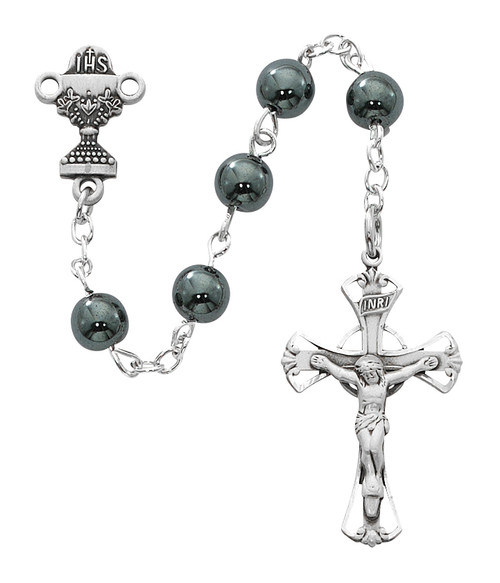 Beautiful First Communion Rosary. This genuine Hematite rosary has a rhodium crucifix and  chalice centerpiece.  Rosary measures 16 1/2"L.  The rosary comes in a Black Leatherette Gift Box. Perfect keepsake rosary for years to come. 