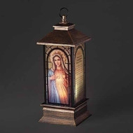 11"H LED Immaculate Heart of Mary Lantern. Lantern is made of plastic. Dimensions: 10.5"H 4"W 4"L.  Lantern is battery operated. 3AA Batteries not included. 