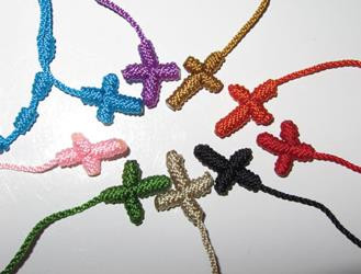 Known in Spanish as "decenarios," these tiny woven rosary bracelets have become very popular. Each bracelet is made of colored threads with ten knots signifying the beads and cross of the rosary. Available in pink, blue, beige, black, red, green, orange, purple and brown.
