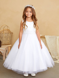 Girl standing in a white sleeveless dress.
