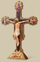 10.5" Ognissanti Standing Crucifix. Resin/Stone Mix. 10.5"H x 7.38"W x 1.25"D. The Ognissanti (All Saints) crucifix, is the work of the 14th-century Italian master Giotto.  For years the 16.4 foot crucifix had been left in a side room of a church, unseen.  This beautiful work of art was returned to the Ognissanti church in Florence in 2010 after ten years of restoration.