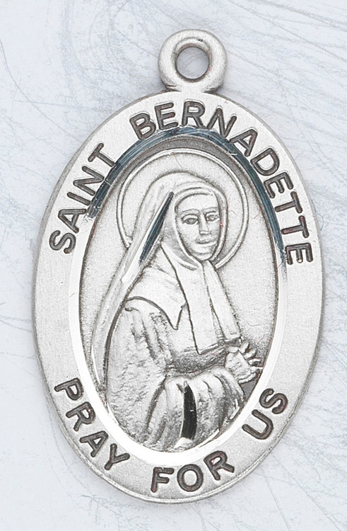 Sterling silver St Bernadette 7/8" oval medal. St Bernadette medal comes on a 18" Genuine rhodium plated fine curb chain. Medal comes in a deluxe velour gift box. Engraving option available. Made in the USA
 
