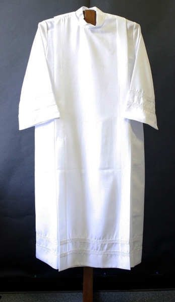 Alb in 100% smooth poplin polyester for easy care. One inch woven lace bands on cuffs and on the bottom of the garment. Your choice of velcro or button closure. Ample Cut sizes available upon request, please contact us at 800-523-7604 for details. (See sizing charts below product descriotion) 
