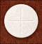 An image of a single communion wafer with a Cross indentation on it. 