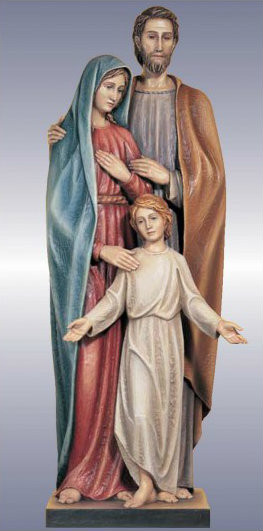 Sculpture of holy family, including mother, father, and child embracing one another. 
