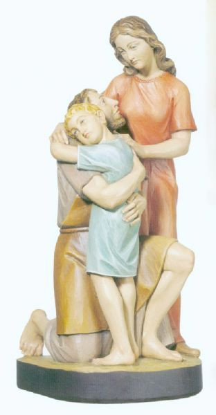 Sculpture of Saint Joseph kneeling with Child Jesus embracing him, and Virgin Mary standing beside them. 
