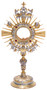 Silver and gold monstrance embellished with intricate design and red rubies