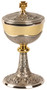 24k gold plated and oxidized silver with Holy Spirit and grapes with leaf design. 4-3⁄4˝ base. 9-1⁄4˝H., 4-5⁄8˝ dia. cup, 250 host cap.
Host capacity based on 1-1/8" host. Complements Chalice 915
