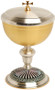 Gold plated and oxidized silver.
4" Base
7 5/8" height, 4 5/8" diameter cup.
300 host capacity (Based on 1 1/8" Host)
Complements Chalice 928

 