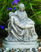 Cement Garden Pieta Statue. Pieta Statue comes in a natural cement finish. Dimensions: Height: 14", Width: 11", Length: 6", Weight: 34 lbs. Statue is handcrafted and made to order. Please allow 4-6 weeks for delivery. Made in the USA
 